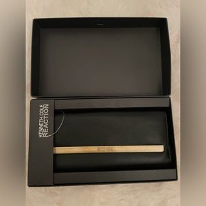 Black, Kenneth Cole clutch. Brand new still in the box.